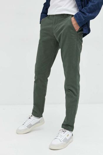 Nohavice Tommy Jeans pánske, zelená farba, priliehavé