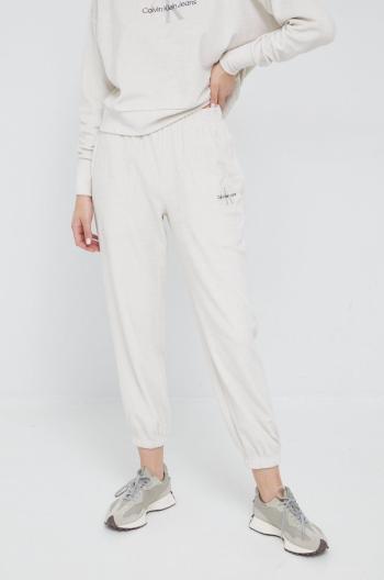 Tepláky Calvin Klein Jeans dámske, béžová farba, jednofarebné