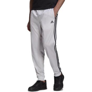 adidas  Tepláky/Vrchné oblečenie Essentials Warm-Up Tapered 3-Stripes  Biela