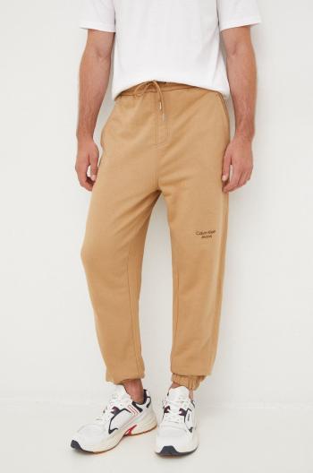 Bavlnené tepláky Calvin Klein Jeans pánske, hnedá farba, s potlačou