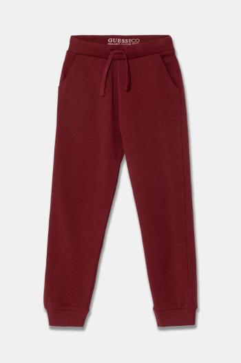 Detské bavlnené tepláky Guess bordová farba, jednofarebné, N93Q17 KAUG0