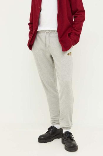 Tepláky Tommy Jeans šedá farba, melanžové